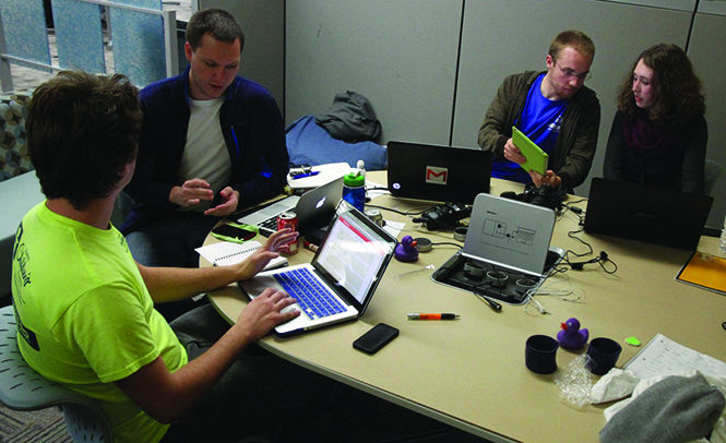 Dakota Grover, Michael Bickerton, Jim Jastatt and Ashley Choi work together during the Hackathon on Saturday, Oct. 19, 2013.