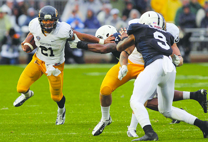 Kent State running back Anthony Meray (left) looks downfield as he pushes away a Penn State defender during the game on Saturday, Sept. 21, 2013. Kent State lost the game at Beaver Stadium, 34-0. Photo by Melanie Nesteruk.