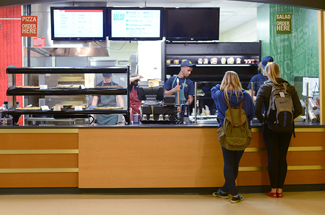 Kent State students order salads, a healthier option, at The Slice in the Hub on Thursday evening, Oct. 16, 2013. Photo by Melanie Nesteruk.