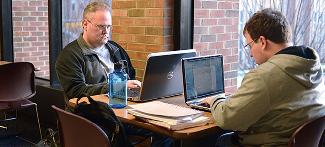 Kent State senior chemistry major Matthew Davis sits with senior Justin Robinson on the second floor of the student center. Davis is one of many nontraditional students attending Kent State. 