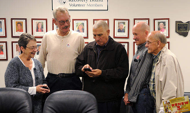 Alberta Caetta, Bill Nome, Dennis Missimi, Joel Mowrey, Gene Mills gather around to view the updated results on Issue 3 at the Mental Health & Recovery Board of Portage County on Tuesday, Nov. 5, 2013. Photo by Rachael Le Goubin