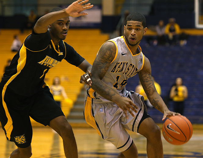 Sophomore guard K.K. Simmons drives the ball toward the basket during the Kent States game against Kennesaw State Sunday, Dec. 1, 2013. The Flashes won the game 68-51. Photo by Brian Smith.