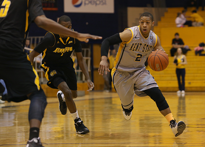 Sophomore Guard Kellon Thomas works his way past the Kennesaw State defense in the MAC Center on Sunday, Dec. 1, 2013. The Flashes won the game, 68-51. Photo by Brian Smith.