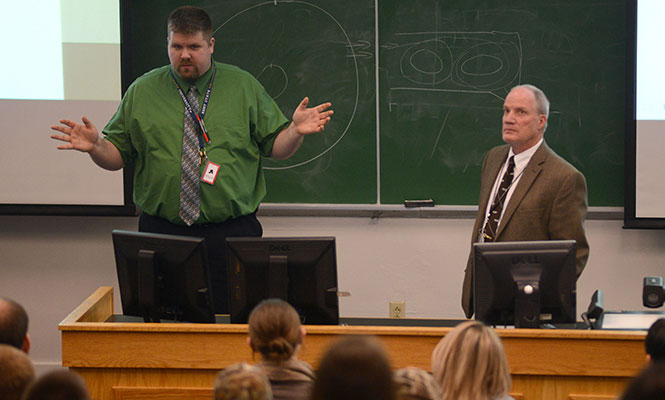 (From left) Assistant air traffic control professor Jason Boergerhoff and assistant flight and air traffic control professor Robert Priestley speak to students of the Kent State aeronautics program about the recent changes made by the Federal Aviation Administration to the air traffic control hiring process, in Van Deusen Hall, Thursday, Jan. 23, 2014. The new process will no longer take applicants job location preference into account when hiring, announced Jan. 10, 2014.