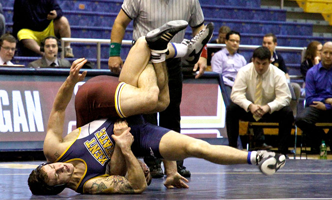 Junior Caleb Marsh takes on Central Michigan opponent Mike Ottinger at the wrestling meet Sunday, Jan 26, 2014 in the M.A.C. Center.