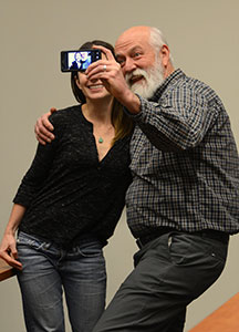  David LaBelle, director of the department of photojournalism, and photographer-filmmaker Maisie Crow smile for a picture together after Crows lecture and film showing for the school of journalism and communication at Franklin Hall, Thursday evening, Jan. 30, 2014.