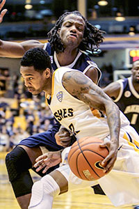 Junior guard Derek Jackson defends the ball from Akron University Saturday, Feb. 1, 2014. The Flashes beat the Zips 60-57, with a three point shot scored in the final seconds of the game.