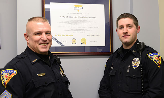 MELANIE NESTERUK | DAILY KENT STATERSargeant Wayne Parker and Officer Kevin Hammer stand in front of the Kent State Polices 7th Certificate of Accreditation Sunday, Feb. 16, 2014.