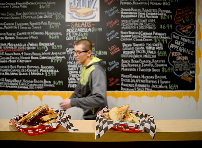 Owner Steve Tannous prepares orders at Twisted Meltz, a new grilled cheese eatery in Acorn Alley, Wednesday, Feb. 5, 2014. The restaurant serves a spectrum of sandwiches named and themed after 17 Kent State-based celebrities.