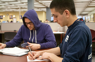 Kent State tutor Adam Delduchetto (Right) works with Ethan Levitt (Left) on trigonometry in the library Tuesday, Feb. 18, 2014.