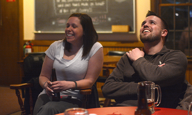 R. Jay Wilkinson, senior marketing major and President of the Kent State Veterans Club (right) laughs with Catherine Hofer (left), senior nursing major who just returned from active duty on Valentines Day, at the Kent VFW on Wednesday, Feb. 26, 2014.