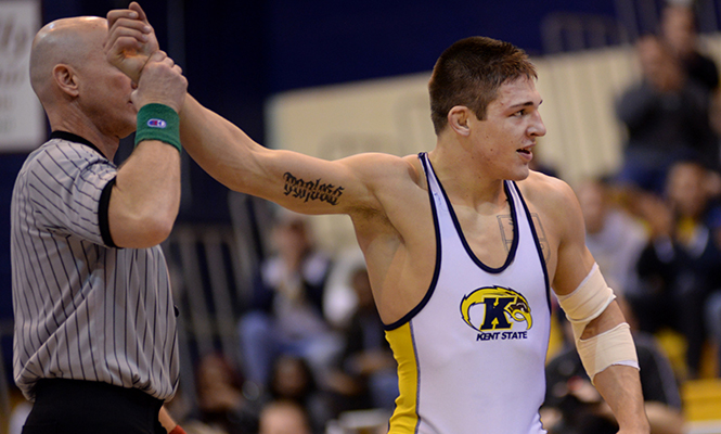 Kent State's Ian Miller celebrates as he wins his final match of the MAC Championship Sunday, March 9, 2014. Miller defeated his opponent from Central Michigan and finished first in his weight class winning him a Mid-American Conference title.