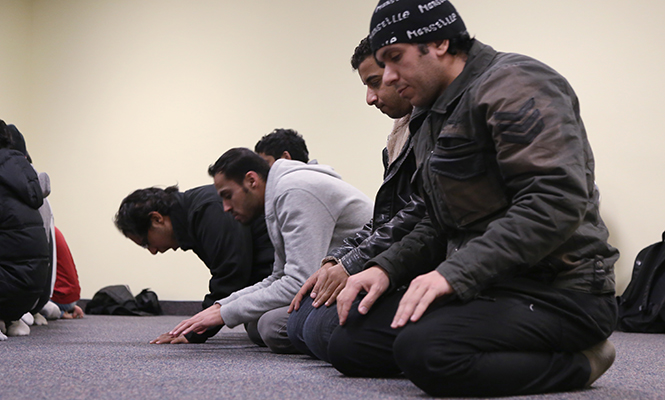 Members of the Muslim Student Association pray in the Student Center November 15, 2013. The act of kneeling and having your forehead, nose, both hands, knees and all toes touching ground is called ‘Sujud’ which gives one a direct connection to God.