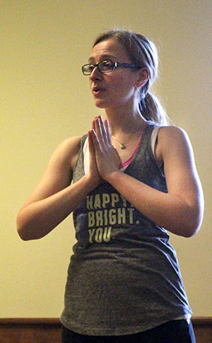 Kent State public health professor and yoga instructor Diana Kingsbury teaches students a yoga pose, Tuesday, Mar. 11, 2014, in room 308 of the Student Center. The class was held for a PHSA fundraiser for which all proceeds went to the PHSA Global Health Fund.