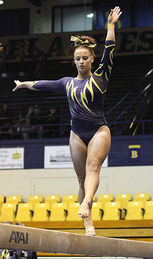 Kent State senior Marie Case prepares for an acrobatic move during her balance beam routine against BGSU March 6, 2014. Kent State won its last home meet of the season with a final score of 196.225.
