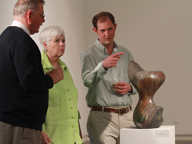 Ceramics grad student Ryan Osborne (right) talks with his mother and father, Maureen and William, at the Masters of Fine Arts Show on Thursday evening April 3, 2014.