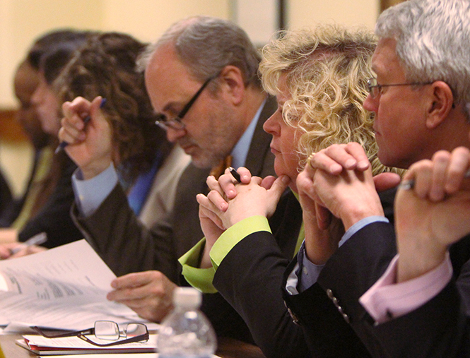 Melody Tankersley (center) listens among other faculty senate members at the meeting in the Governance Chambers, March 17, 2014.