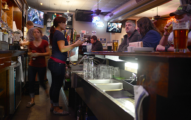 The Rays Place staff keeps busy behind the bar Tuesday night during the Indians vs. Padres game, April 8, 2014.