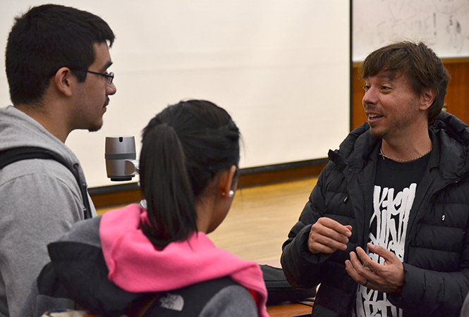 Architect Leonardo Diaz-Borioli (right) talks with freshman architecture students Rebecca Alanis and Felipe Valadez after he presented some of his work Tuesday, April 15, 2104 in Bowman Hall.
