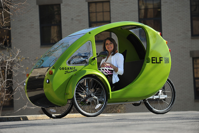 Paulette Washko, director of research compliance in the Division of Research and Sponsored Programs, commutes to campus using her solar powered battery bicycle the ELF car.