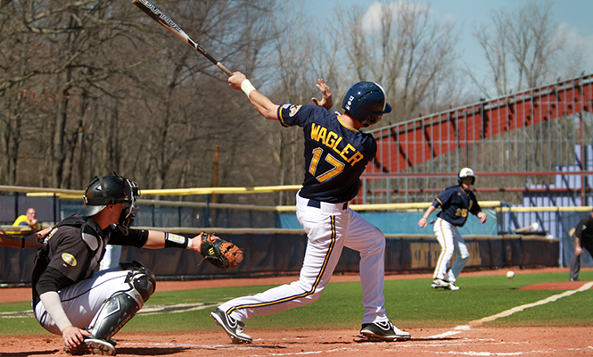 Sophomore infielder Justin Wagner hits a line side ball during the first doubleheader held against Oakland University on Tuesday, April 1, 2014. Kent State is set to face Ohio University this weekend.