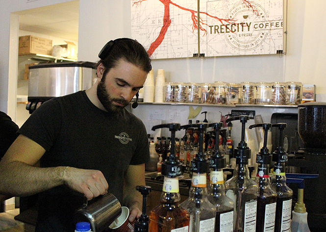 Tree City barista Owen Park prepares a cup of coffee at Tree City in Kent on April 7, 2014. Tree City was voted best coffee shop in Kent.