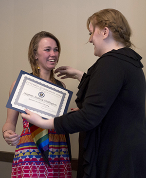 Senior Meghan Shillington receives a rainbow stole at the Lavender Graduation, a pre-commencement celebration for LGBTQ and Ally Students Tuesday, April 29, 2014. The ceremony is an opportunity to for students to recognize their family, a partner or friends for their support.