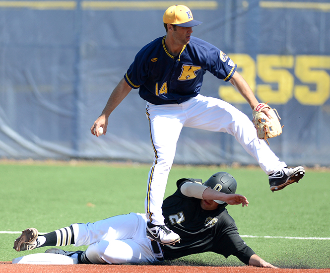 Junior Sawyer Polen tags out opponent Trent Pell before throwing the ball to first and making a double play. Kent played a doubleheader game against Oakland University at Schoonover Stadium April 1, 2014. The Flashes won 16-5 in the first game and 16-1 in the second game.