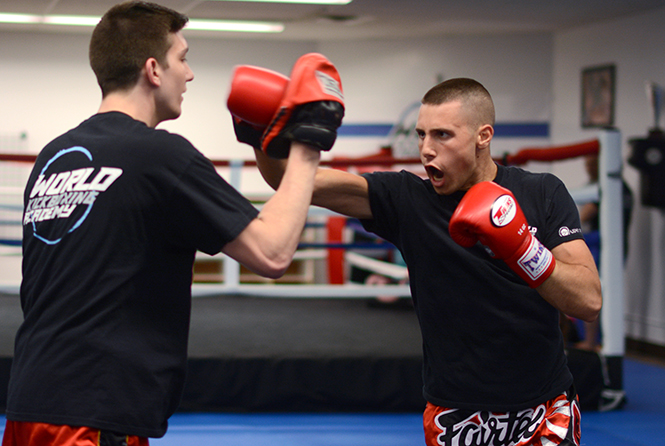 Bobby Koch (right), sophomore aeronautics major spars with Tyler Peacock (left), junior communications major after a Thursday night practice at World Kickboxing Academy in Stow, Ohio Thursday, April 4, 2014. Both students teach boxing and have performed fighting sports for the majority of their lives.