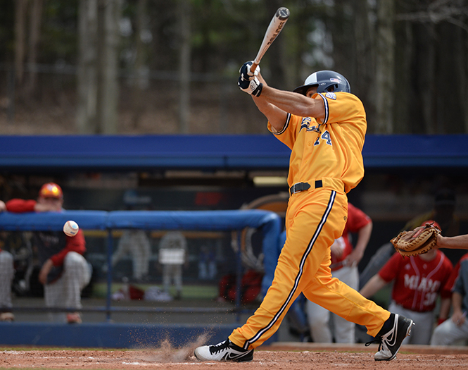 Junior infielder Sawyer Polen makes contact with a pitch at the game against Miami University Sunday, April 13, 2014. The Flashes played a three game tournament winning two out of the three games. They lost Sundays game, 4-6.