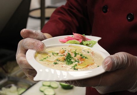 Cook Shaun Rizk prepares a plate of hummus at Laziza restaurant in downtown Kent, April 7, 2014. Laziza was voted best for its vegetarian selection.