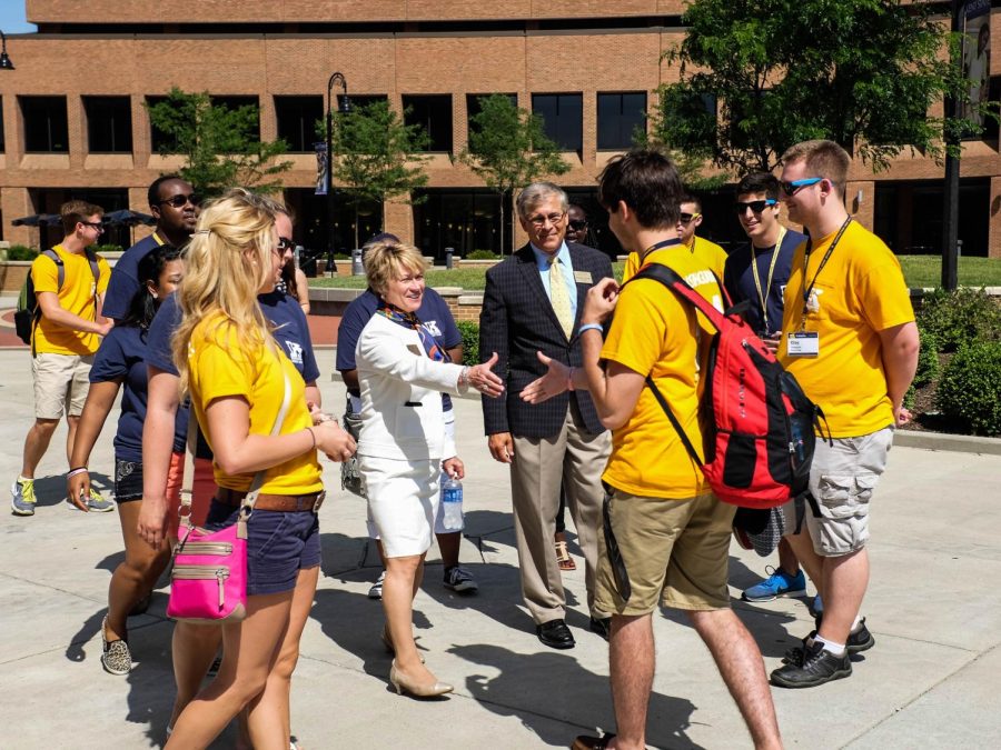 President Beverly Warren reaches to shake the hand of a Flash Guide outside the Kent State Student Center on July 1, 2014. Warren spent her first day focusing on university students. 