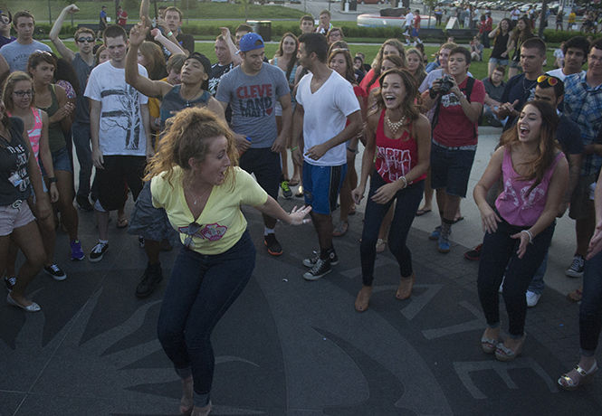 Students gather to watch a dance off as Evan Evolution performs during BlastOff Sunday, August 24, 2014 on the Student Green