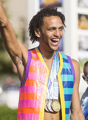 Tom Gay, an athlete in the Gay Games, displays his medals as he walks in the parade as part of the closing ceremonies Aug. 16, 2014