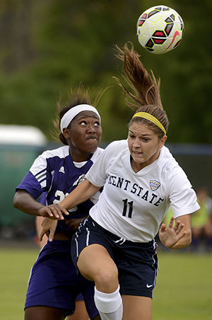 Kent State freshman Mackenzie Lesnick heads the ball against Western Illinois opponent Devan Jones at the season opening game on Friday, August 22, 2014. The Flashes beat the Leathernecks 3-0.