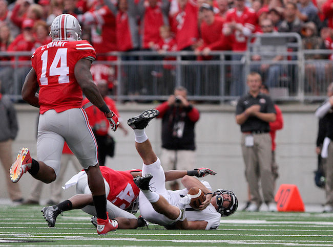 Colin Reardon, Kent States quarterback, is sacked by an Ohio State defensive player at the Kent State vs Ohio State game Saturday, Sept. 13, 2014. Reardon was sacked three times throughout the game and the Flashes fell to the Buckeyes with a final score of 66-0.