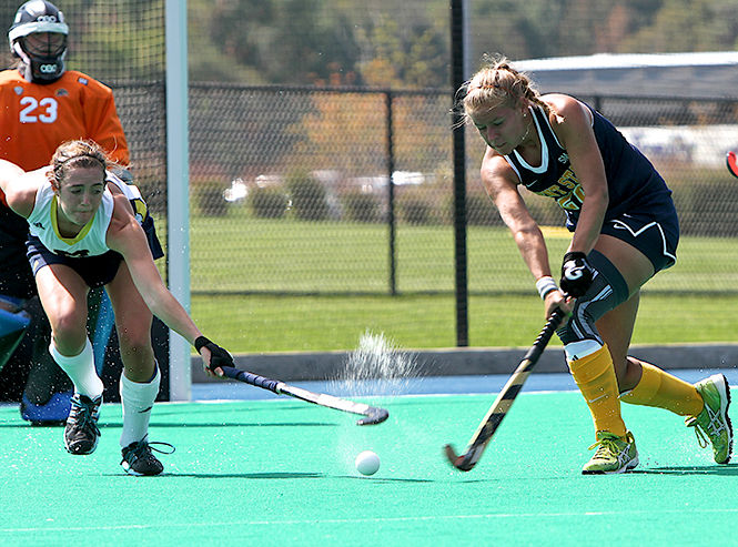 Kent State Junior Susanne Felder attempts to steal the ball at the field hockey game against the Univeristy of Michigan Sunday, Sept. 21, 2014. The Flashes lost the game 3-2.