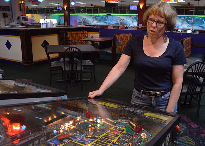 Jessie Carduner, associate professor of Spanish and French, plays pinball at Stonehedge Family Fun Center in Cuyahoga Falls Friday, Sept. 12, 2014.