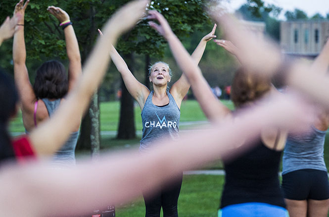 The Kent Stater Beachbody Coach and Fitness Instructor Jessie Perry leads members of Kent Chaarg in an outdoor PiYo Session on Friday, Sept. 5, 2014 outside Tri Towers. Kent Chaarg is a new all girls fitness organization lead by Charrg ambasador and Nutrition major Madison Jordan.