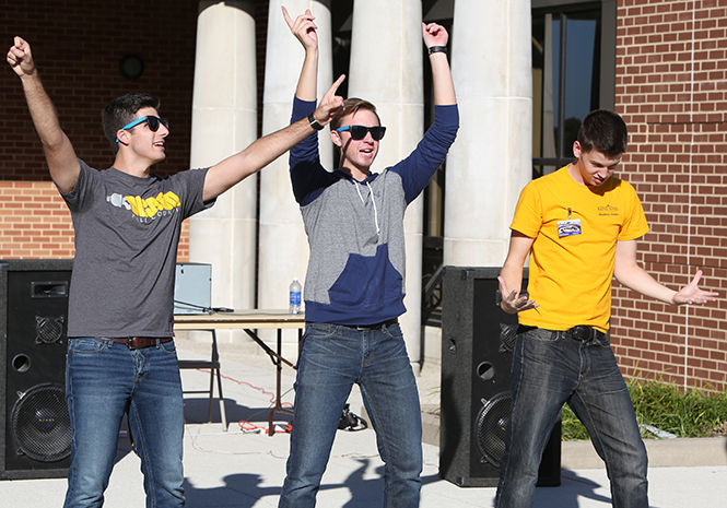 From left to right, sophomore communication studies major Corey Patterson, junior journalism major Ian Klein and junior electronic media major Zac Gundlach sing and dance to the Backstreet Boys at Rock the Quad on Wednesday, Sept. 24, 2014.