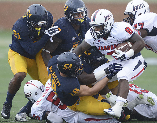 Kent State defensive linemen tackle University of South Alabamas Jay Jones at the football game September 6, 2014. The Flashes will take on The University of Virginia on Saturday.