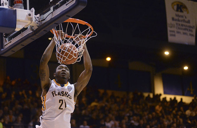 Sophomore forward Khaliq Spicer dunks the ball in the game against Akron University Saturday, Feb. 2, 2014. The Flashes won 60-57 to defeat the Zips with a final three point basket scored in the last moments of the game.