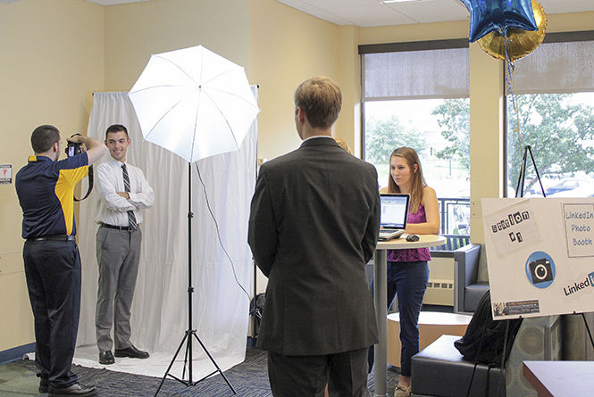 Matt Cowles, photographer for the College of Business photographs Shane Alesi, managerial marketing freshman at the LinkedIn photo booth during the COB business kick off event Tuesday, Sept. 9, 2014.
