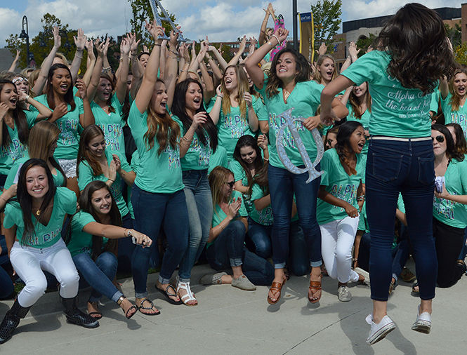 The Kent Stater members of Alpha Xi get the crowd pumped up Sunday, Sept. 21, 2014, at Kent States sorority recruitment.