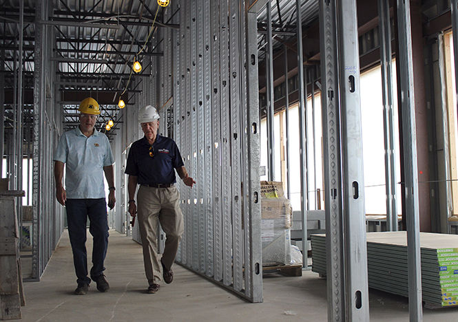 Joe Karpinski (left), Coordinator of Construction Management, and Robert Sines (right), dean of Kent State Universitys College of Applied Engineering, Sustainability and Technology, take a tour of the CAEST building during construction on July 11, 2014.