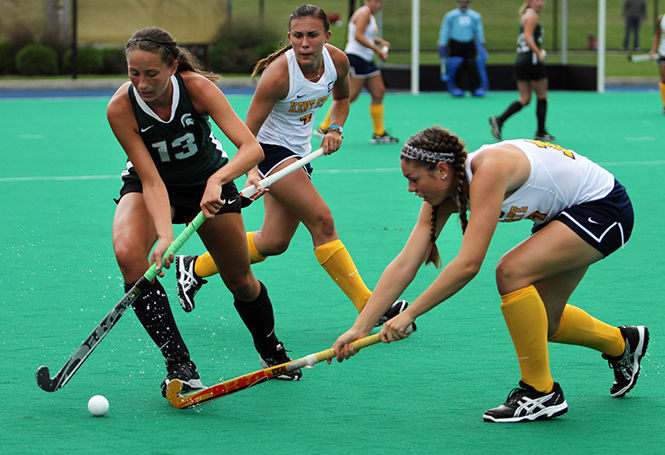 Kent State senior Shannon Martin reaches to steal the ball from Michigan State's Michelle Graham during a match Saturday, Sept. 13, 2014. Kent State lost 3-4.