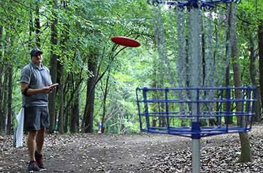 Marc Metzker makes a putt at the inaugural Frisbee Golf Tournament on the new Frisbee Golf Course. September 21, 2014.