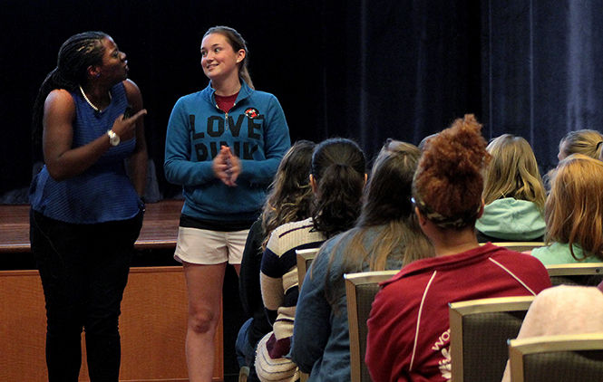 Michelle Guobadia asks Carmela Mostardi, junior finance major and a member of Chi Omega, what pledging is during her discussion on hazing to the Kent State Greek Community in the Student Center Ballroom Tuesday, Sept. 23, 2014.
