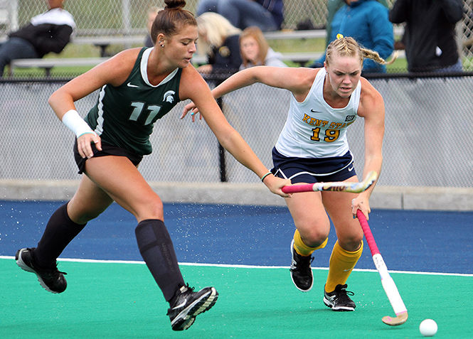 Kent State sophomore Madison Thompson tries to take the ball past Michigan States Jenni Smith during a match Saturday, Sept. 13, 2014. Kent State lost 3-4 in overtime.