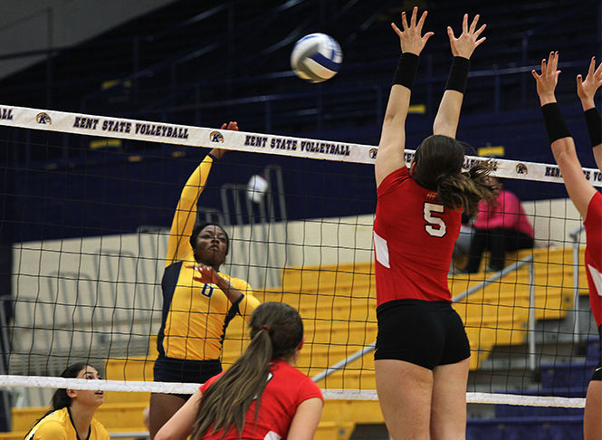 Tinuke Aderemi-Ibitola, outside hitter, hits the ball against Youngstown State University to gain a point at the game Sept. 16, 2014. The Flashes won, 3-2.